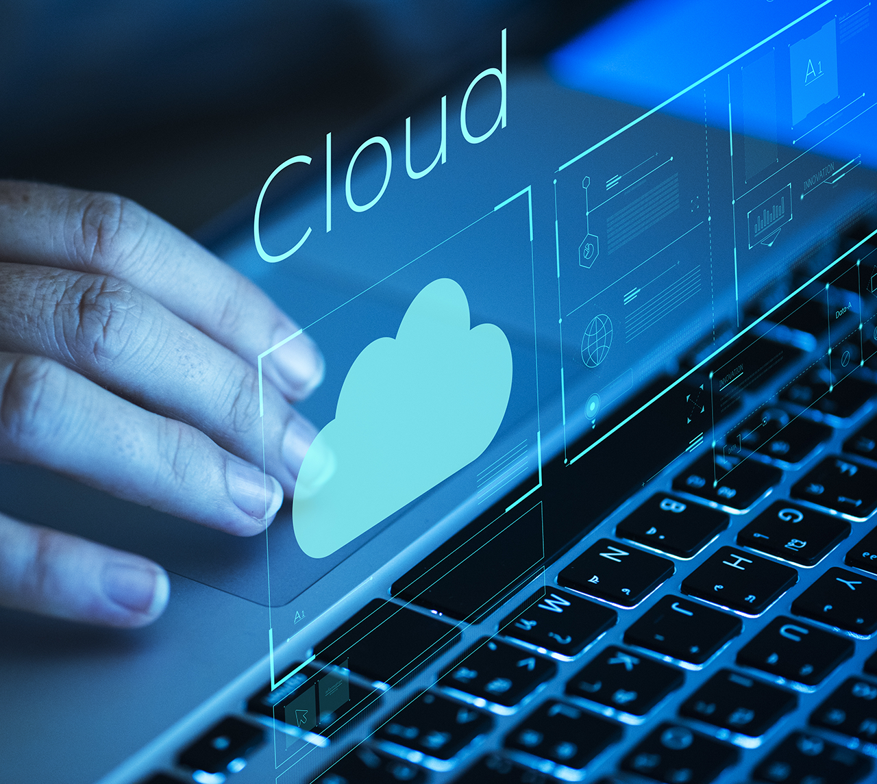 a hand using the computer with 3D display the cloud symbol above the keyboard