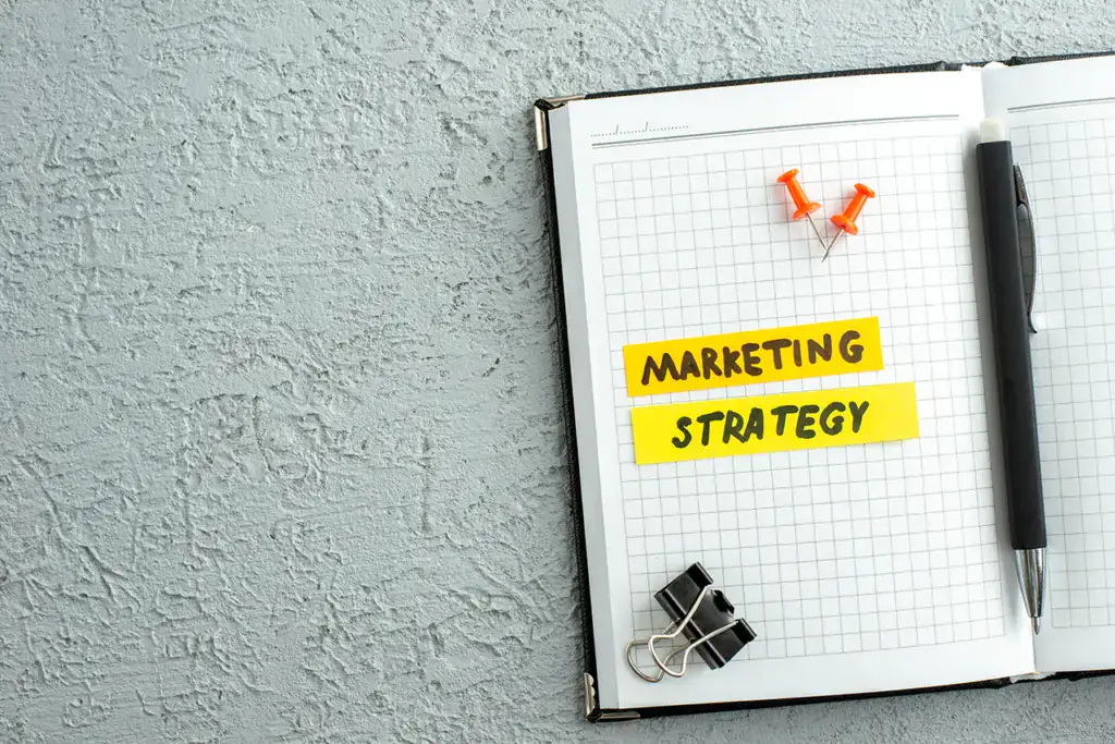 A notebook labeled with a marketing strategy